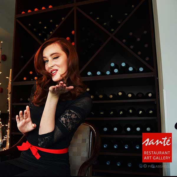 Model sitting for a pose infront of wine rack. piolabsreel